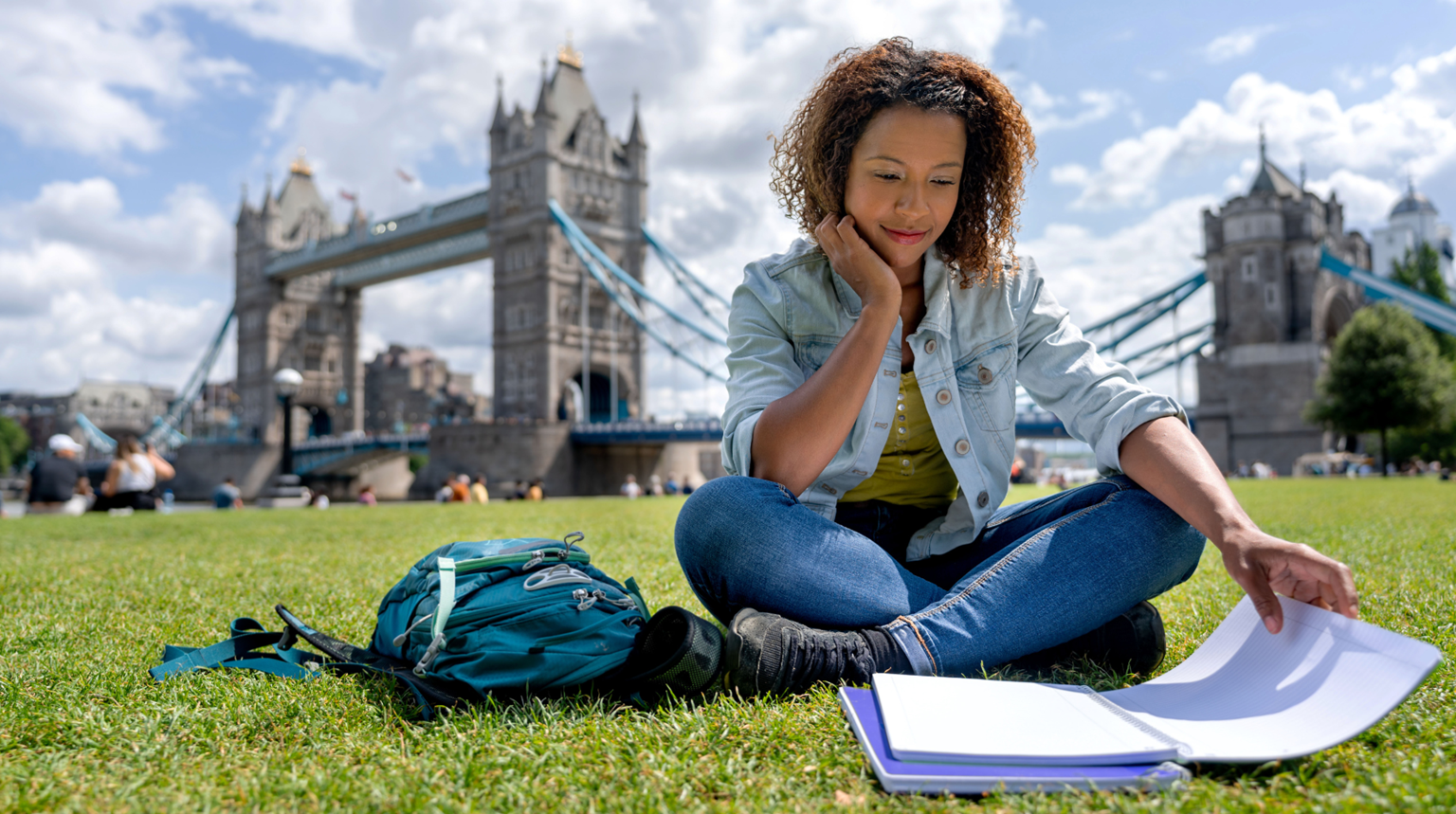 Student studying near the Tower bridge